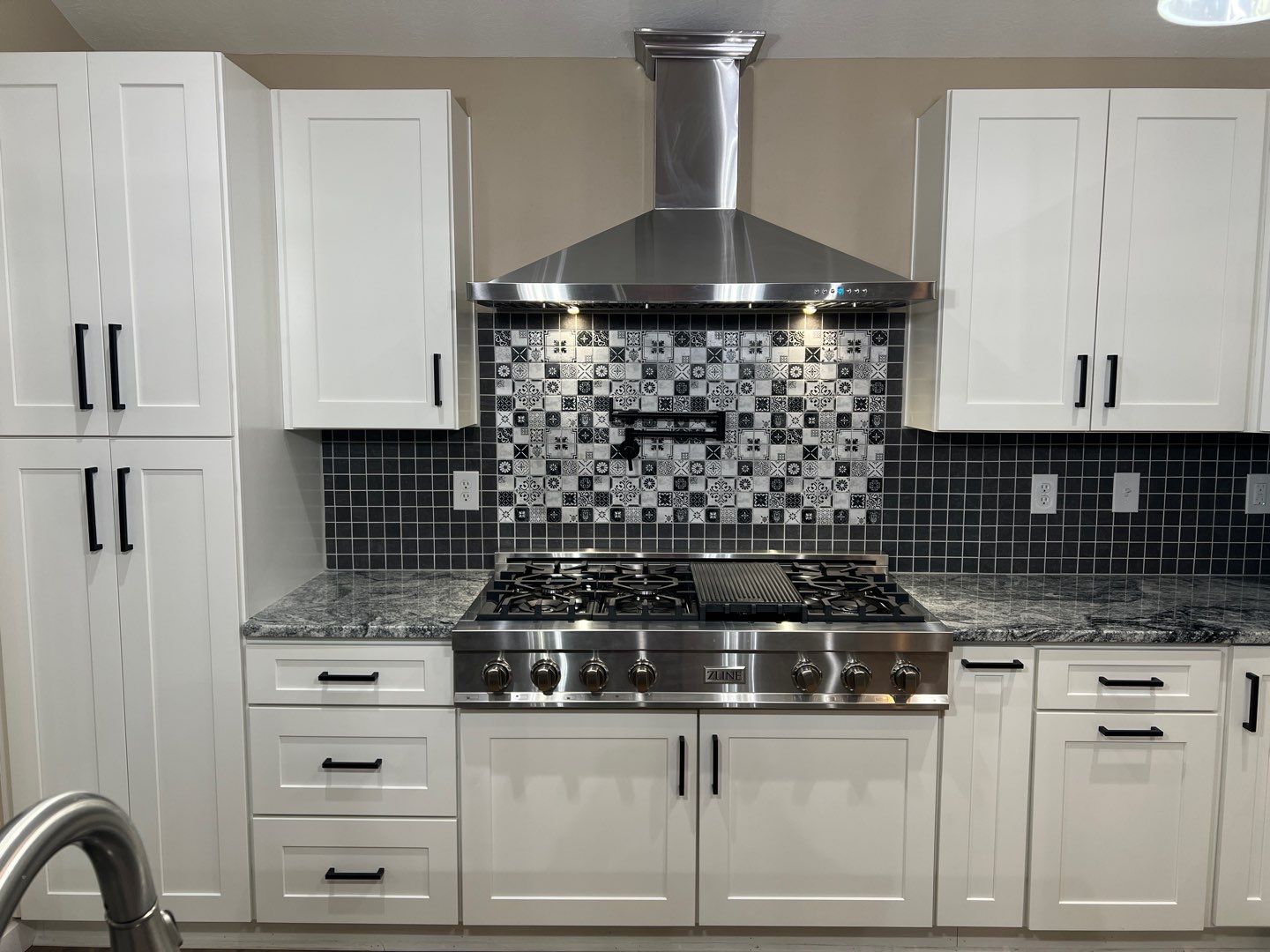 Modern kitchen with decorative tile backsplash and stainless appliances