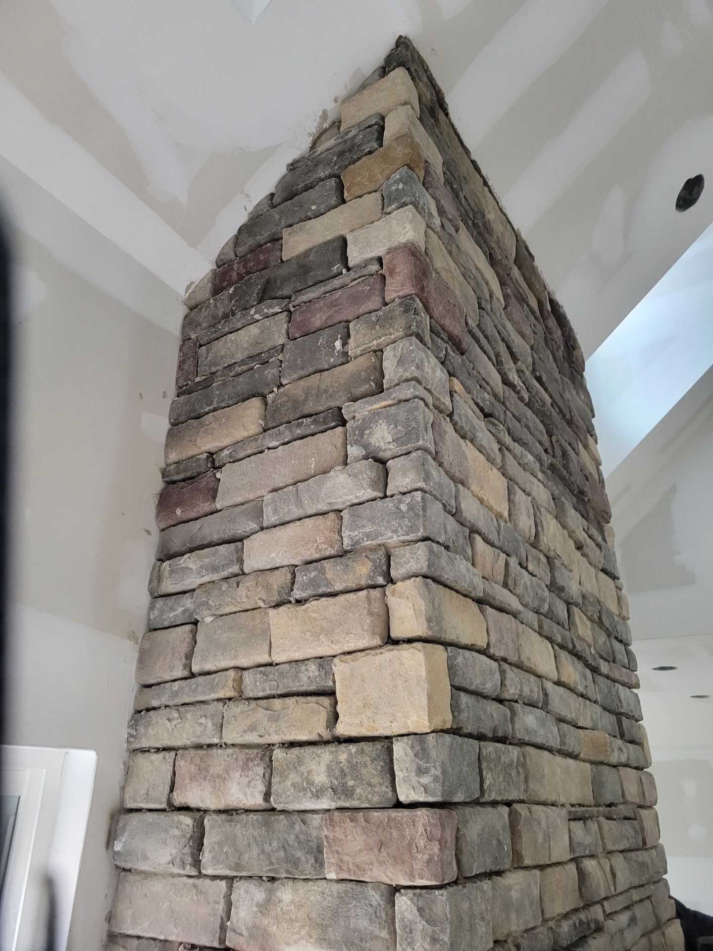 Floor-to-ceiling stone fireplace with cathedral ceiling