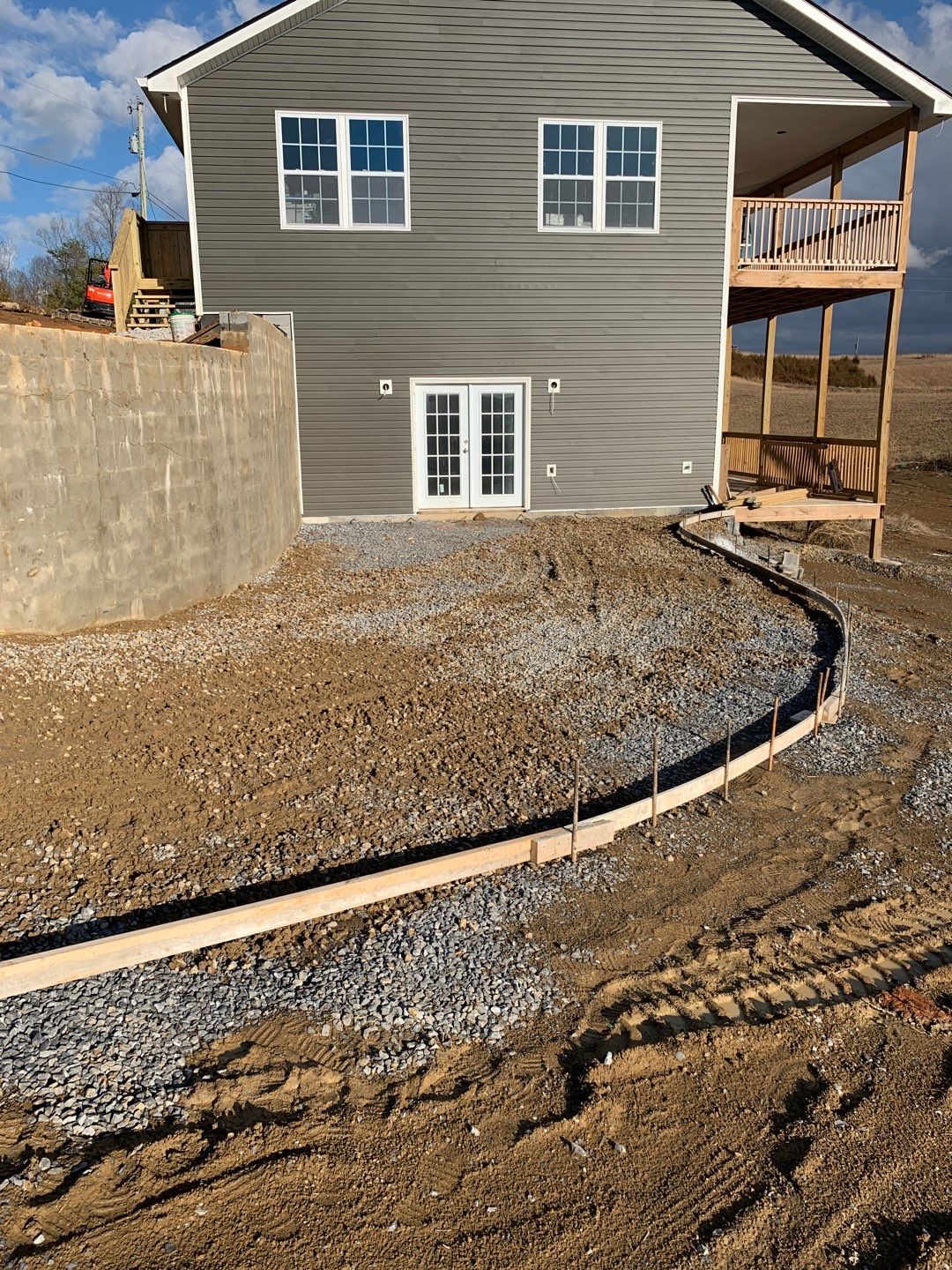 Custom home exterior with curved driveway forms