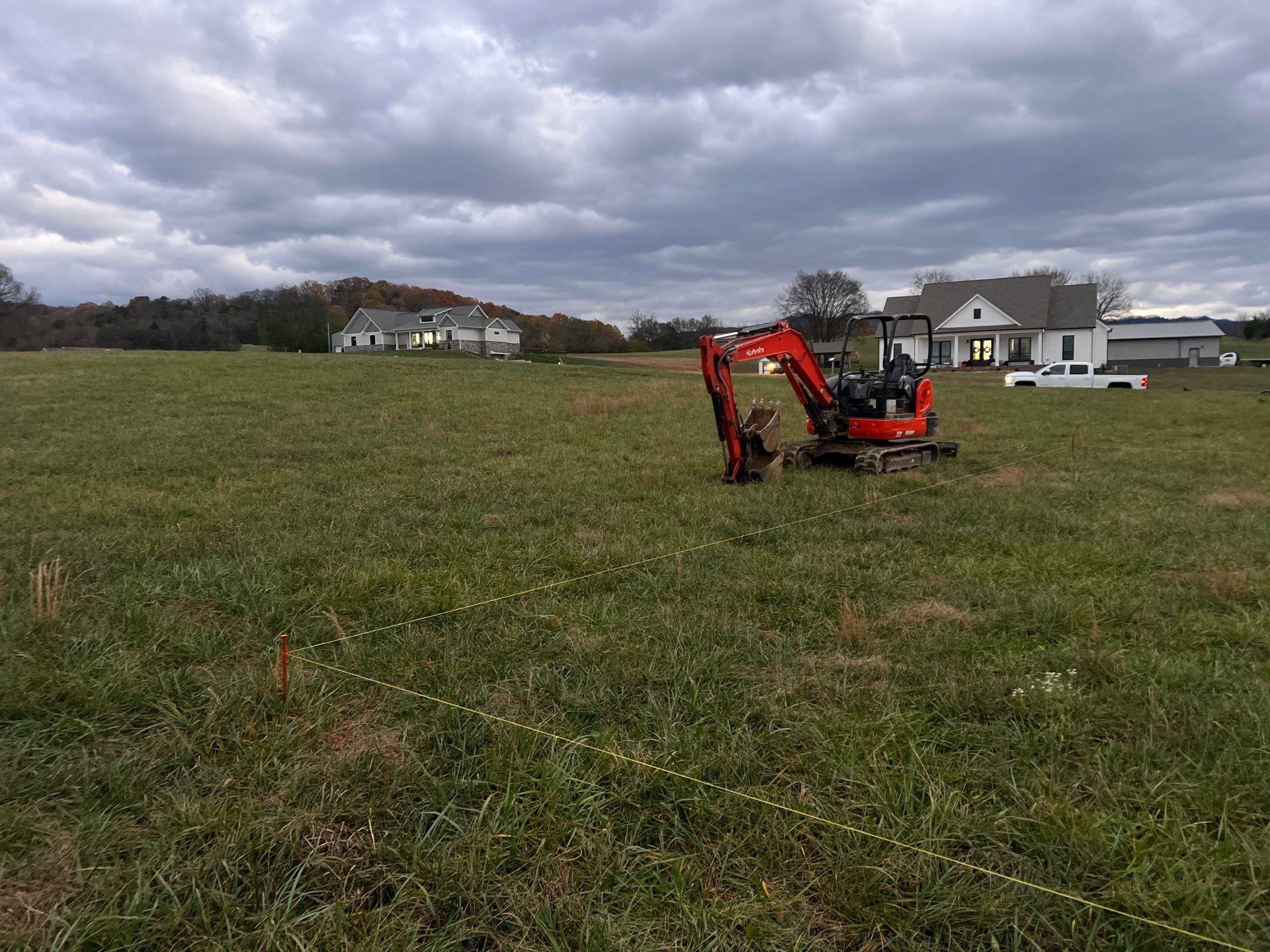 Excavator on job site with string lines