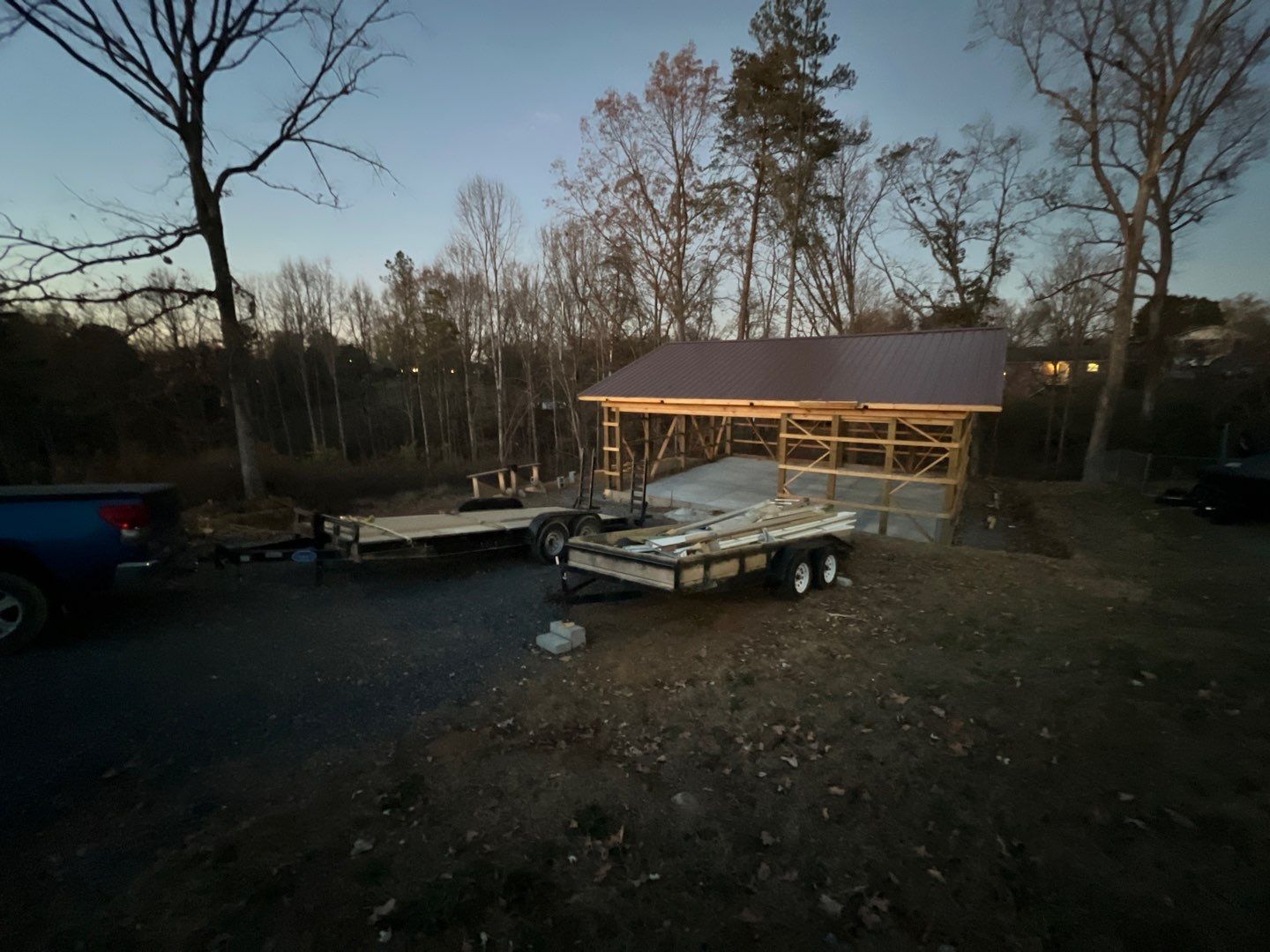 Pole barn structure with metal roof at dusk