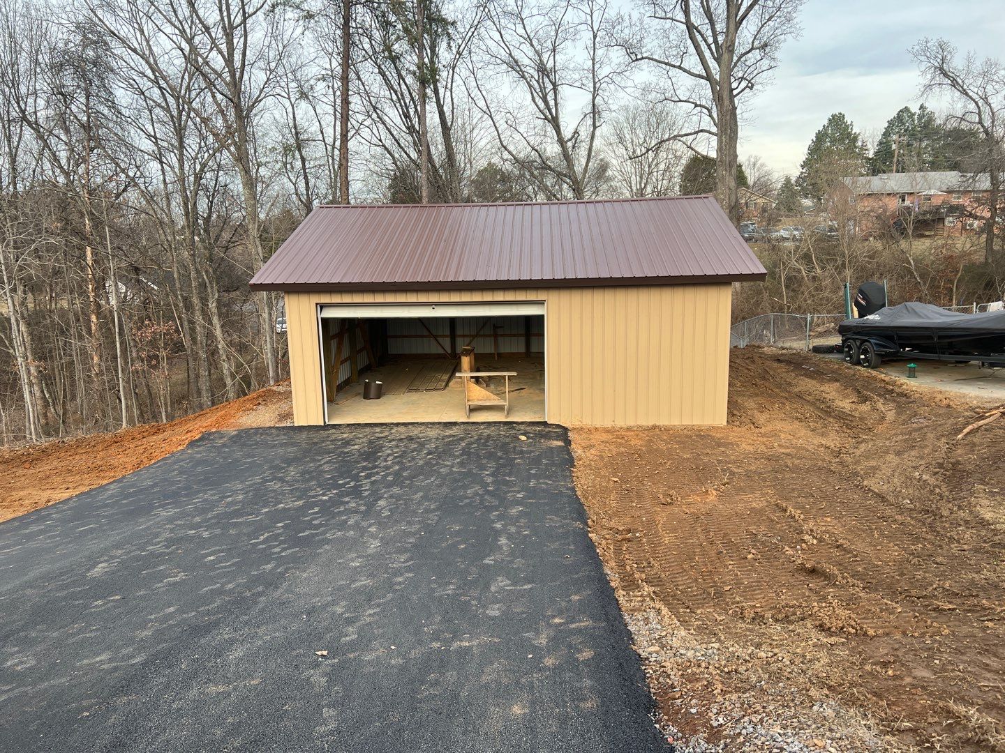 Finished pole barn with new asphalt driveway